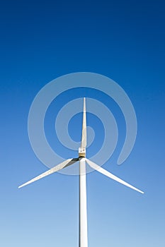 Frontal view of a Windmill taken from below with blue sky in the background