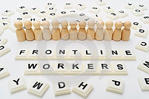 Frontline Workers Words With Line of Wooden Peg Doll Figurines photo