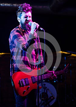 Frontman concept. Musician with beard play electric guitar