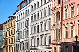 The fronts of some renovated old apartment buildings