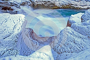 Frost-covered rocks along mountain river banks