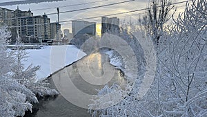 Frost on everything: trees, wires. Winter. River. City