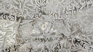 Frost on glass. Frosty drawing. Frozen glass in winter