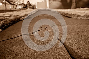 Frost heave crack in residential concrete sidewalk