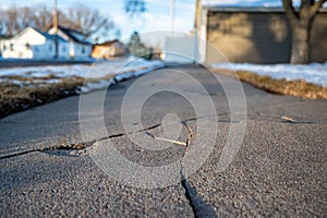 Frost heave crack in residential concrete sidewalk