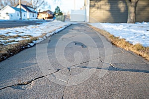 Frost heave crack in residential concrete sidewalk