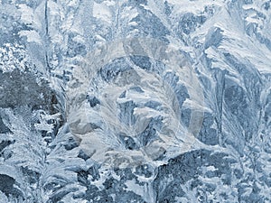 Frost pattern, ice flowers on window glass photo