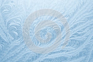 Frost patterns on window glass in winter season. Frosted Glass Texture. Blue background