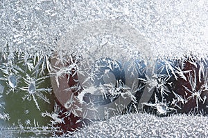Frost patterns on the window, hoarfrost background. Frosty Christmas pattern on the winter window glass. Copy space, natural