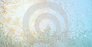 Frost And Sun on glass in winter. Blue Pattern ice on window