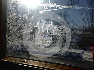 Frost on Window Pane with Sunlight Shining