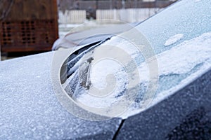 Frostbitten car in the morning of winter is covered with ice and frost