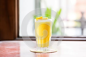 a frostcovered glass of mango lassi indicating a refreshing cold drink