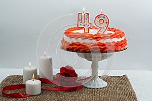 Frosted cake with 49 candle