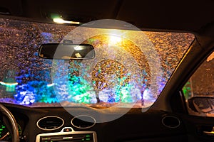 Frosted car glass. snow covered car windshield