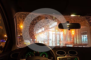 Frosted car glass. snow covered car windshield