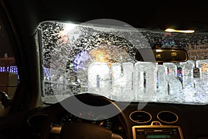 Frosted car glass. snow covered car windshield