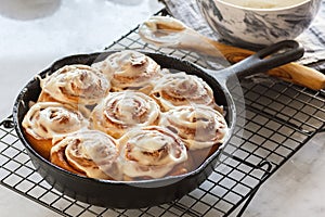 Frosted Cinnamon Rolls in Cast Iron Skillet