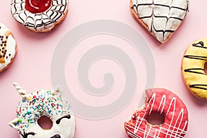 Frosted donuts on pink background