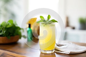 frosted glass of pineapple juice with a sprig of mint on top