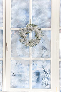 Frosted window with festive and holiday decorations
