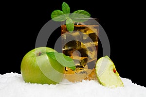 Frosty apple juice,ice cubes and apple with leaves on black on snow