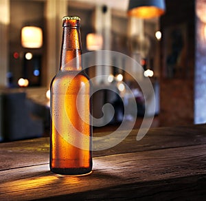 Frosty bottle of light beer on the bar counter.