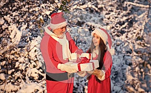 Frosty christmas morning. Santa and granddaughter. Time for miracles. Generous Santa Claus. Child happy girl outdoors
