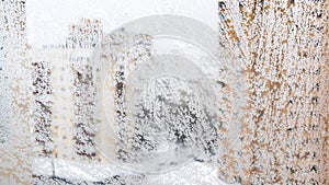 Frosty home window and view of apartment houses