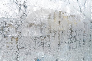 Frosty ice pattern on the glass in winter