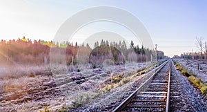 Frosty morning sunrise at the traintracks leading into the unknown distance