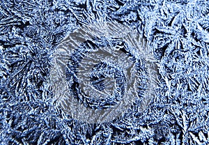 Frosty natural pattern on the window.Frozen patterns on the glass.Winter ice embroidered lace background.Frosted icy texture.