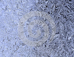 Frosty natural pattern on the window.Frozen patterns on the glass.Winter ice embroidered lace background.Frosted icy texture.