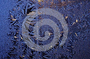 The frosty natural pattern on the cold winter windowpane
