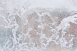 Frosty pattern on glass winter window, look through glass