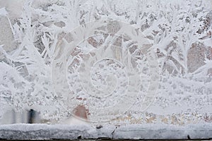 Frosty pattern on glass winter window, look through glass