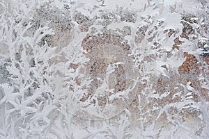 Frosty pattern on glass winter window, look through glass