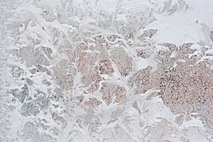 Frosty pattern on glass winter window, look through glass