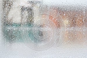 Frosty pattern on glass winter window, look through glass