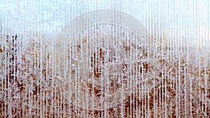 Frosty pattern of hoarfrost and snowflakes on striped glass, winter or Christmas background, texture