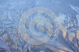 Frosty Pattern on the window in winter. Winter background. Aggregate state of water. Patterned background