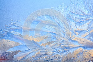 Frosty Pattern on the window in winter. Winter background. Aggregate state of water. Patterned background