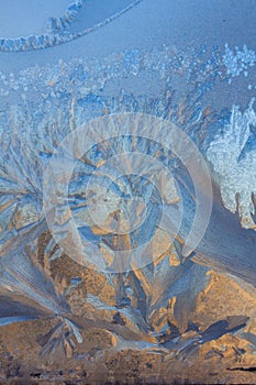 Frosty Pattern on the window in winter. Winter background. Aggregate state of water. Patterned background