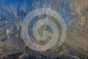 Frosty Pattern on the window in winter. Winter background. Aggregate state of water. Patterned background