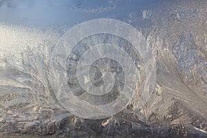Frosty Pattern on the window in winter. Winter background. Aggregate state of water. Patterned background