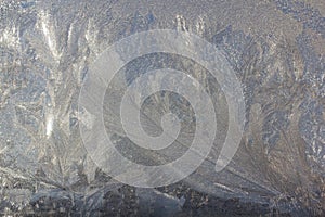 Frosty Pattern on the window in winter. Winter background. Aggregate state of water. Patterned background