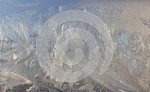 Frosty Pattern on the window in winter. Winter background. Aggregate state of water. Patterned background