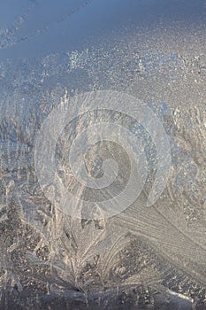 Frosty Pattern on the window in winter. Winter background. Aggregate state of water. Patterned background