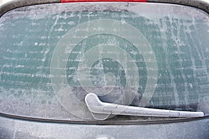 Frosty rear window of car photo