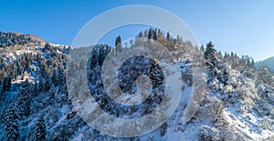 A frosty and sunny day is in mountains, view from above